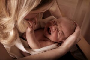 colic crying unsettled baby in parent's arms